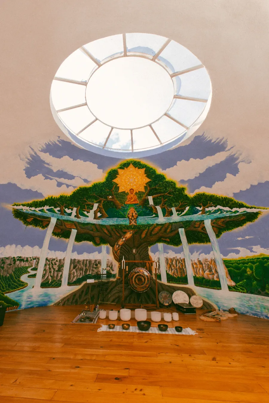 Sound Dome mural with a central sun, tree, and gong